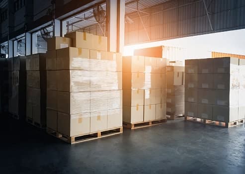 Palletised machinery and goods stored in a warehouse