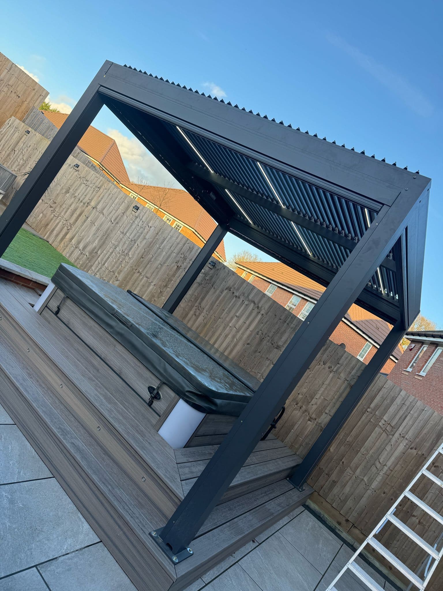 Two-person team installing a garden pergola